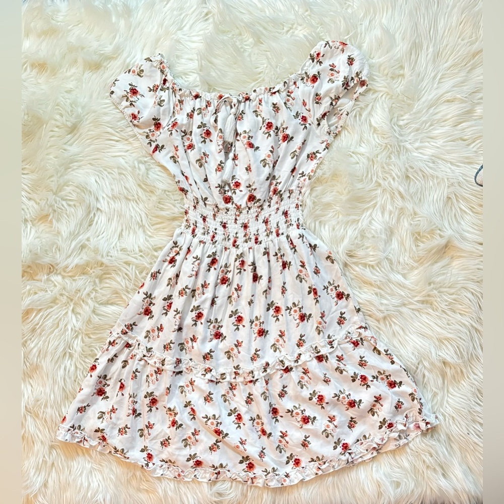 Women’s off shoulder dress, color white and floral pattern.